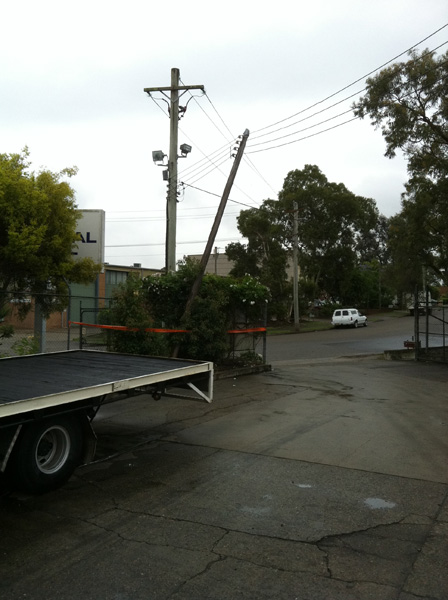 Condemned private pole only staying up by the overhead power lines ready to fall over