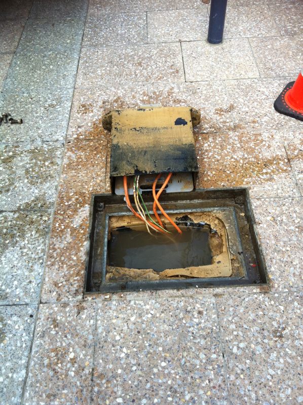 Electricity pit was live due to water drainage error installed by another contractor